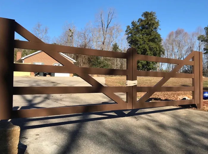 Close view along the Virginia Farm Gate, showing the flat rails running into the rounded-capped centre stiles and a brace cutting down across them.