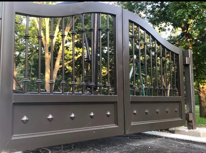 A second build of the same design in a bronze-brown finish, photographed close under the arch with the pyramid studs raised across the bottom panel.