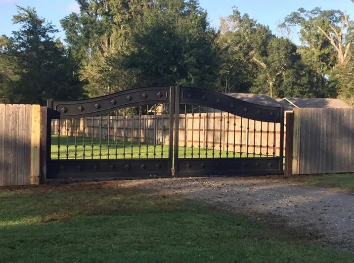 The Mayeaux Gate from further down the drive, showing how it sits into the run of wood privacy fence.