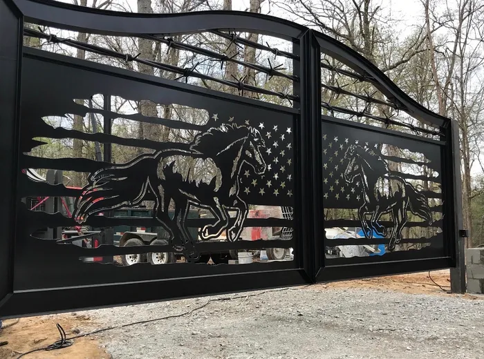 The same horse-panel gate closer in and from the left, the top rail's curve running down to the hinge stile and daylight showing through the cut stars.