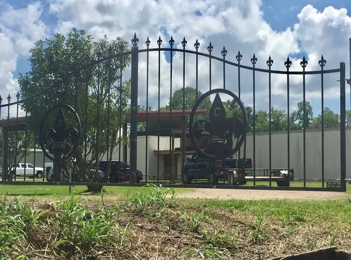 The MCA Gate seen from a distance along the fence line, closed across the entrance.