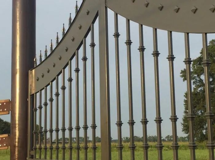 Close angled view along the Disotell Gate, the arch profile and the depth of its posts reading clearly, the pair running out of frame at the right.