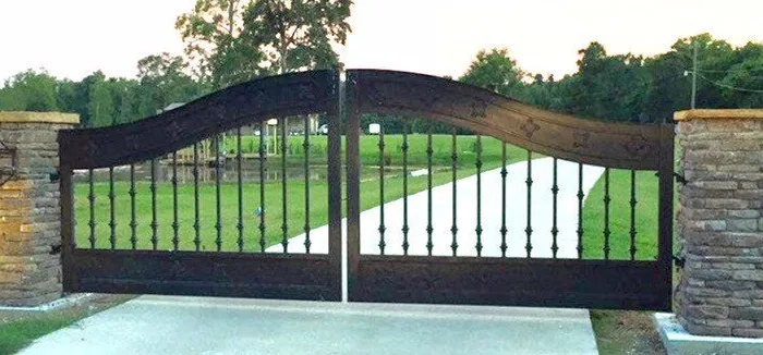 Wide view of the closed Ham Gate across the full width of the concrete drive.