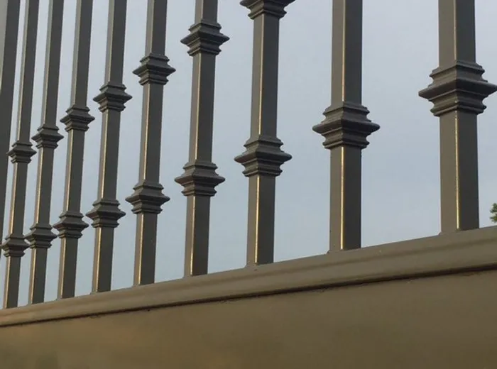 Detail of the pyramid studs and knuckled balusters along the gate's lower rail.